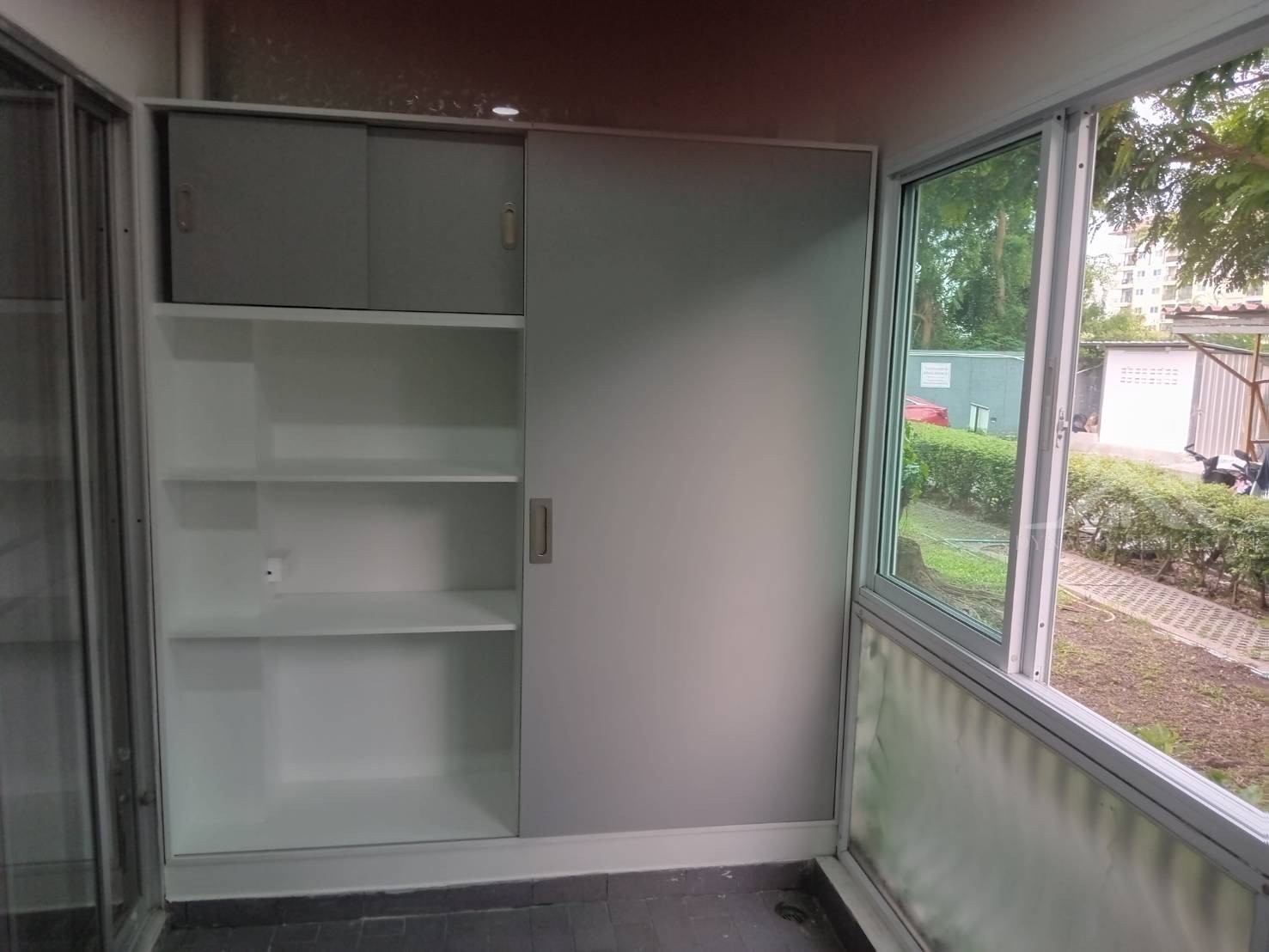 Completed: Built-In Wardrobes And Bathroom Vanity At Baan Suan Lalana For Sale In Pattaya Built-in storage cabinet with grey sliding doors, top cabinets and white shelves installed at a baan suan lalana condo, jomtien