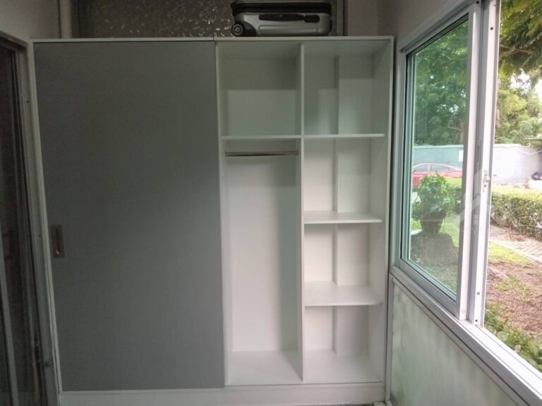 Built-in wardrobe with grey sliding door, hanging rail and adjustable shelves installed at a Baan Suan Lalana condo in Jomtien, Pattaya