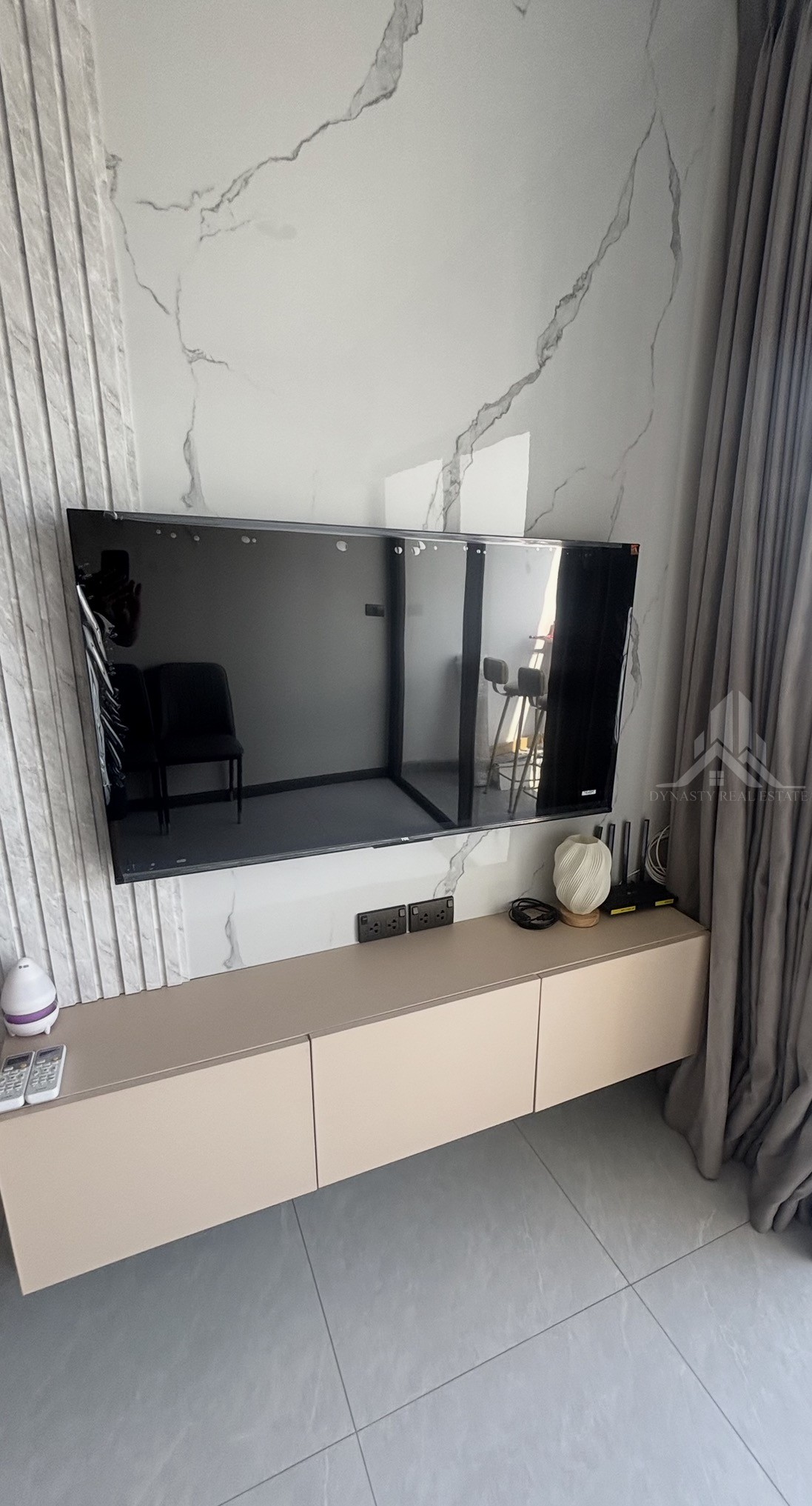 Completed: Built-In Furniture Renovation At Treetops Pattaya Condo For Sale In Pattaya Floating three-door built-in tv cabinet under a wall-mounted tv in a treetops pattaya condo
