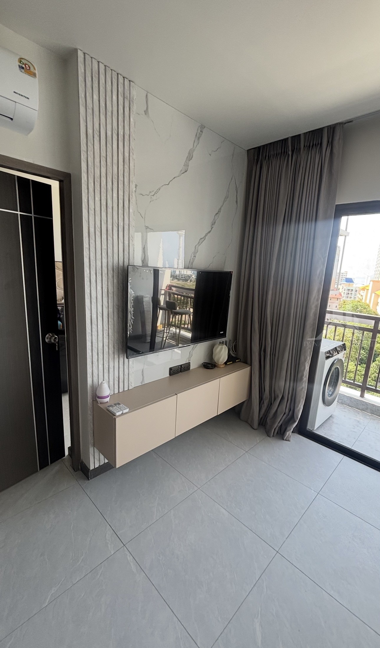 Completed: Built-In Furniture Renovation At Treetops Pattaya Condo For Sale In Pattaya Treetops pattaya condo living room with floating tv cabinet, marble-look feature wall and balcony view